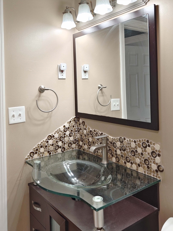 8 9th Street, Unit 406 Medford, MA 02155 - Photo 15 of 21 a bathroom with a sink and a mirror