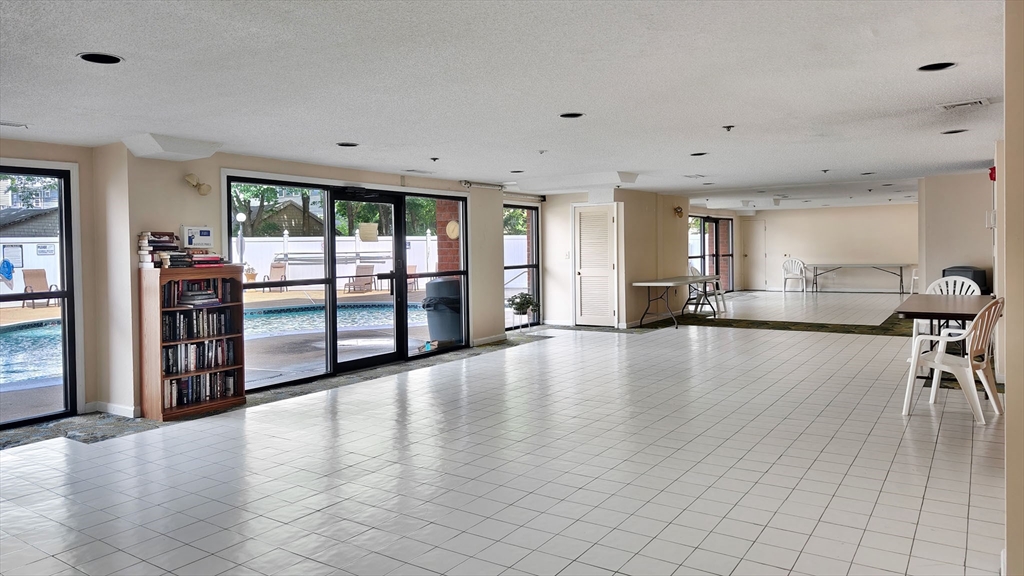 8 9th Street, Unit 406 Medford, MA 02155 - Photo 20 of 21 an empty room with wooden floor and windows