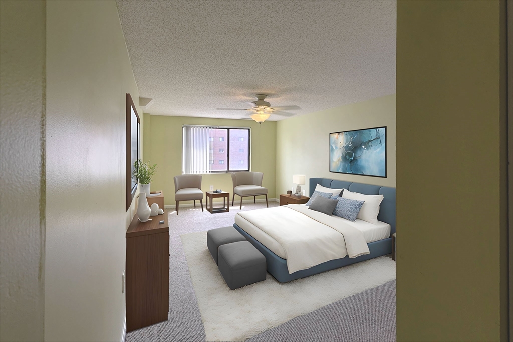 8 9th Street, Unit 406 Medford, MA 02155 - Photo 8 of 21 a bedroom with a bed couch and window