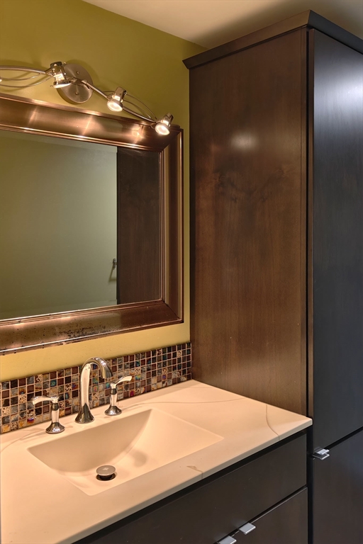 8 9th Street, Unit 406 Medford, MA 02155 - Photo 10 of 21 a bathroom with a sink and a mirror