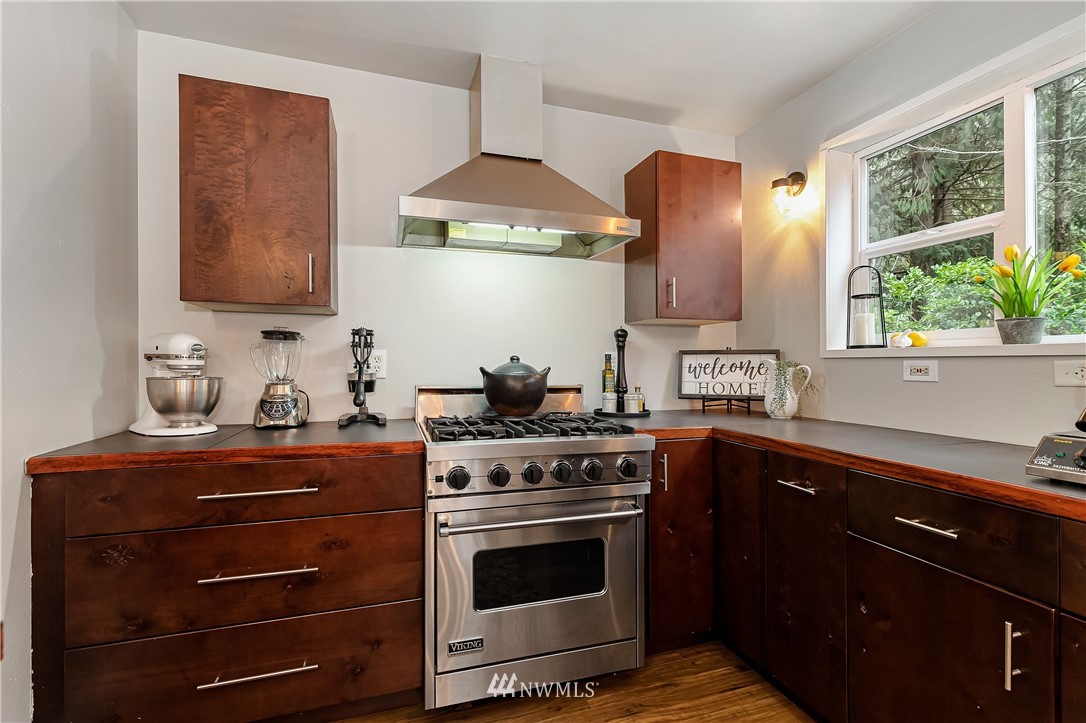 467 Cove Road Bellingham, WA 98229 - Photo 15 of 40 a kitchen with stainless steel appliances a stove and a sink