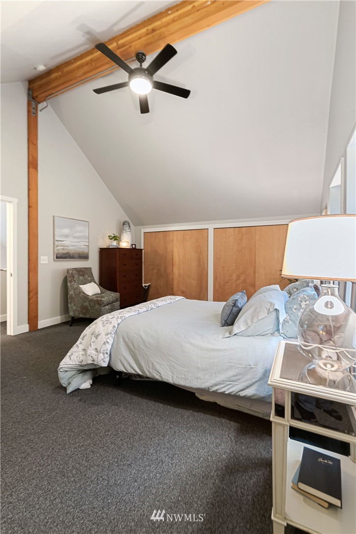 467 Cove Road Bellingham, WA 98229 - Photo 18 of 40 a bedroom with a bed and a chandelier