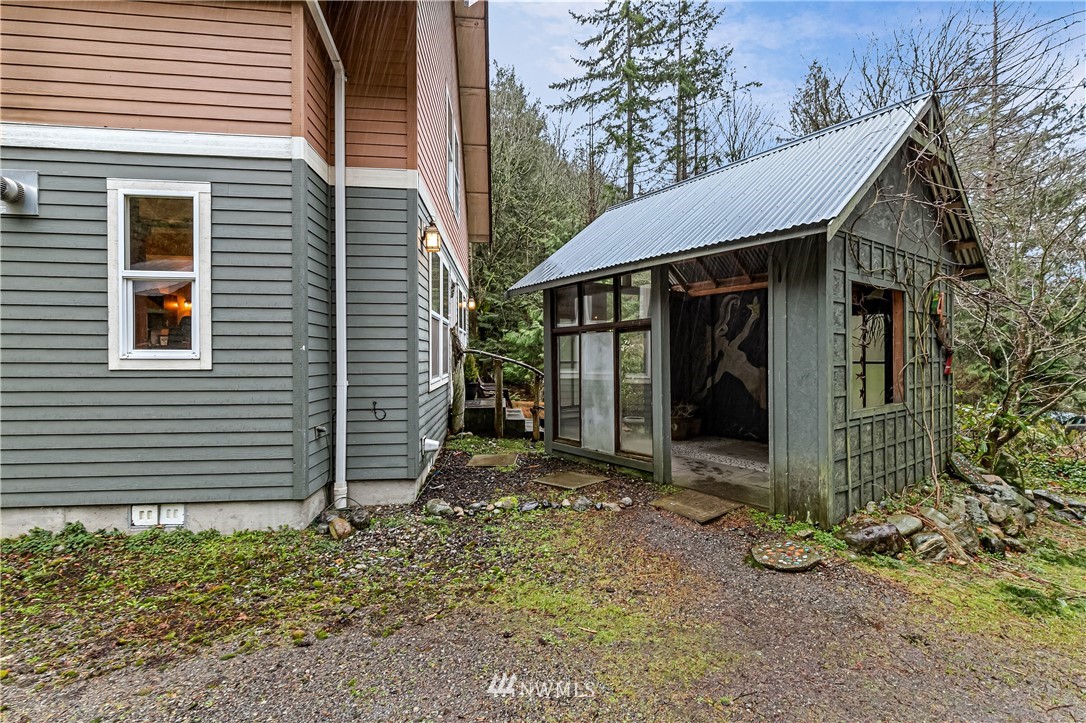 467 Cove Road Bellingham, WA 98229 - Photo 3 of 40 a view of a small house with a tree in the yard