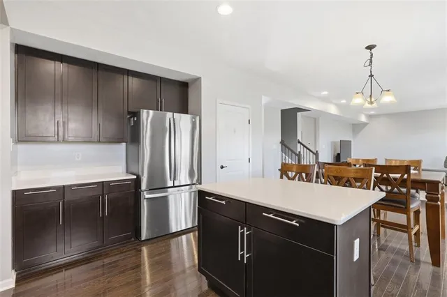 a kitchen with a refrigerator a sink and a stove