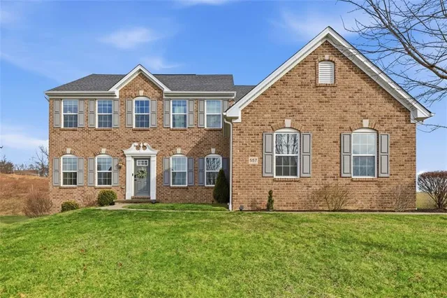 a front view of house with yard and green space