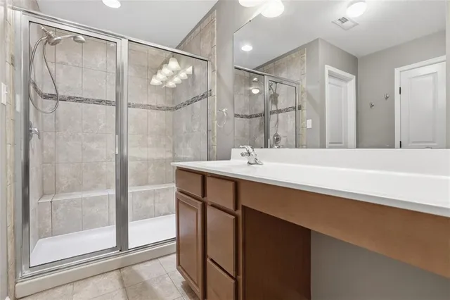 a bathroom with a shower sink and mirror