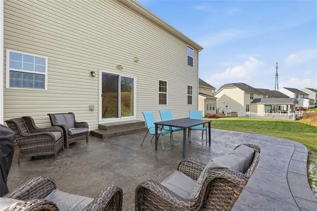 a view of a patio with table and chairs and couches