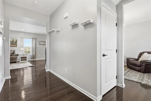 a view of a hallway view with furniture and wooden floor
