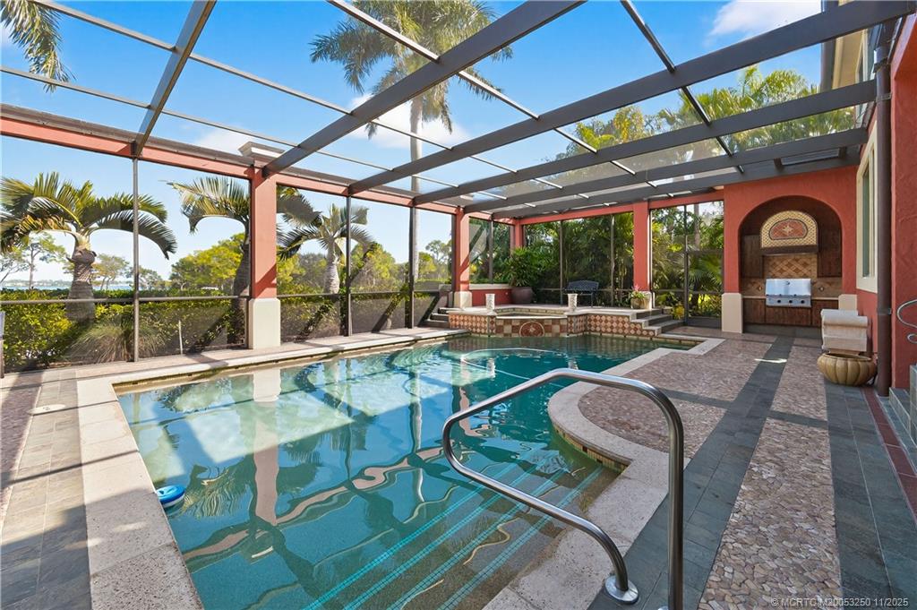 1210 Northwest Winters Creek Road Palm City, FL 34990 - Photo 54 of 73 Screen Enclosed Pool with Spa overlooking the mile-wide St. Lucie River