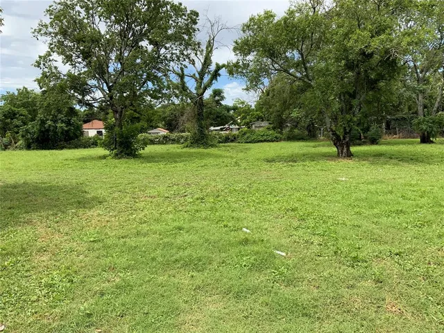 a view of a field with trees