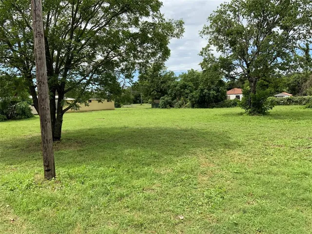 a view of field with trees in the background