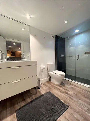 a bathroom with a double vanity sink toilet and shower
