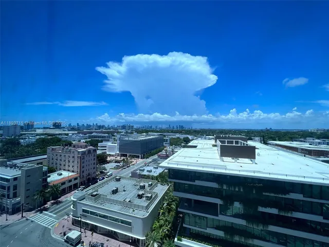 a view of a balcony with wooden floor and a ocean view