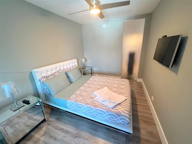 a bedroom with a bed and flat screen tv