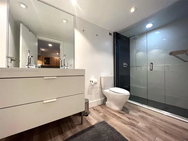 a bathroom with a toilet a sink and mirror