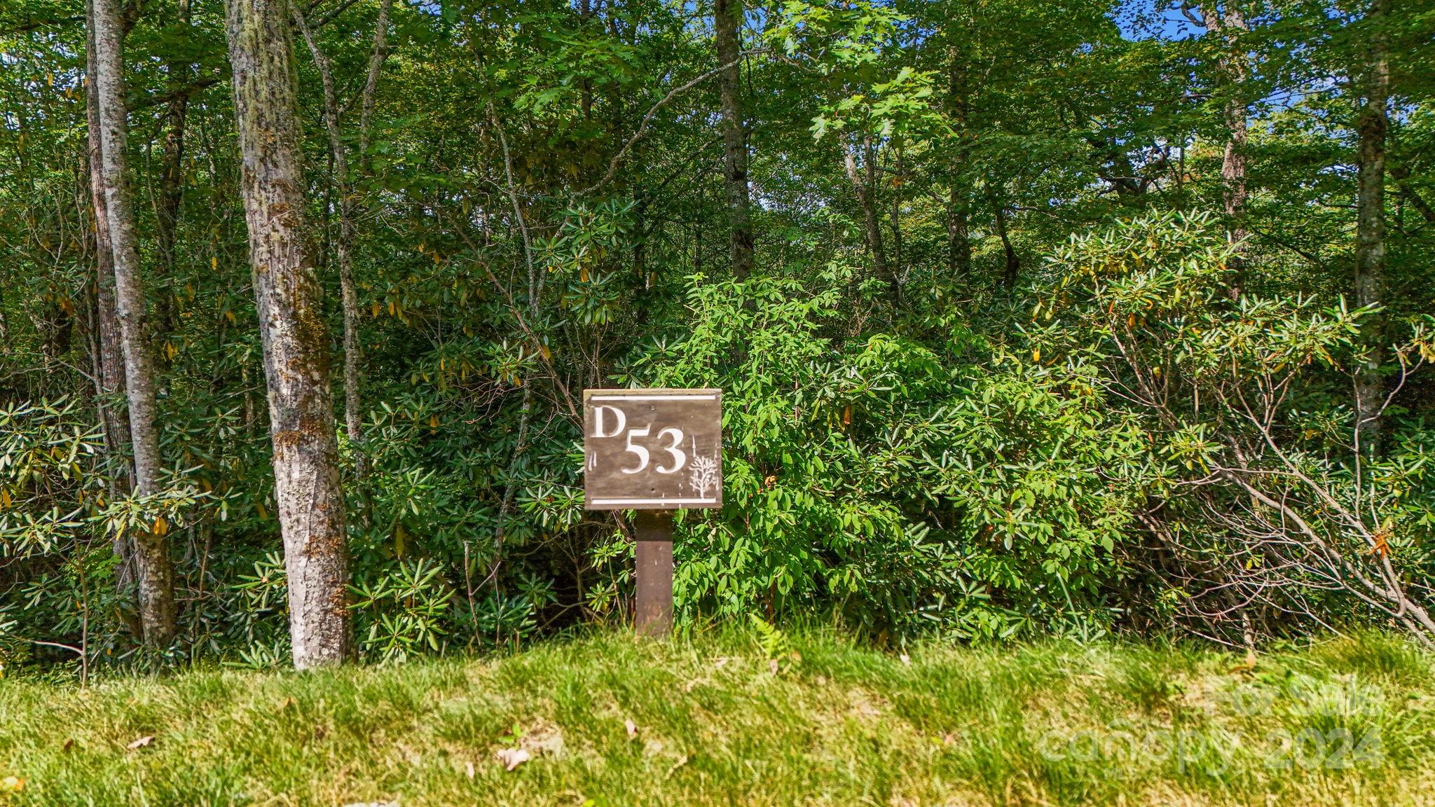 Lot D52 Springwater Road Glenville, NC 28736 - Photo 11 of 47 a sign broad in front of a red brick house