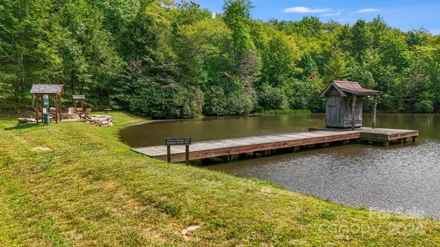 a view of a lake with couches chairs and a yard
