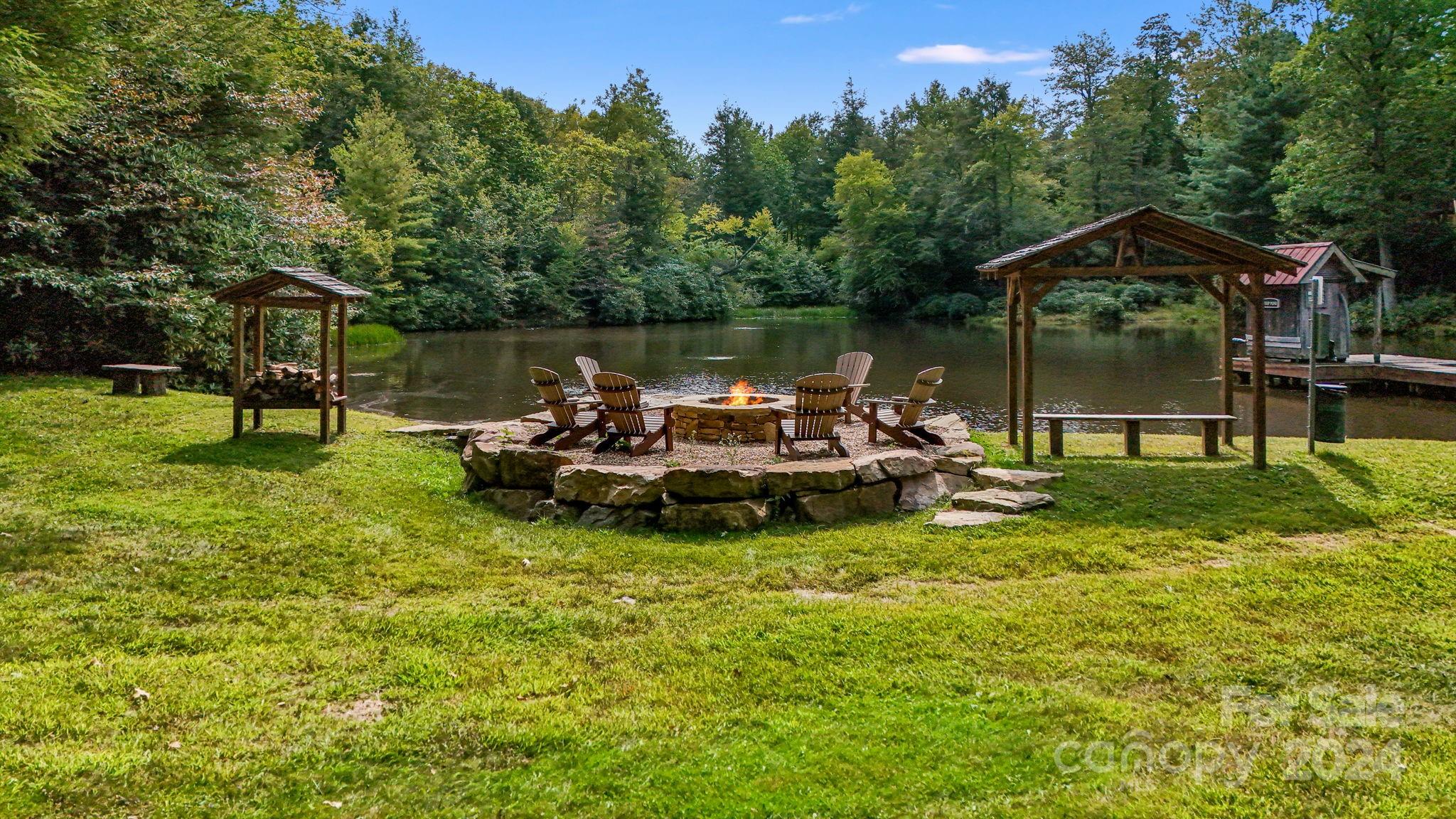 Lot D52 Springwater Road Glenville, NC 28736 - Photo 23 of 47 a view of a lake with couches chairs and a yard