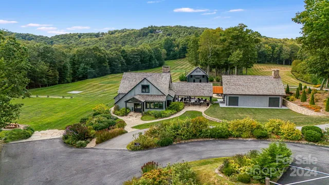 an aerial view of a house with garden space and street view