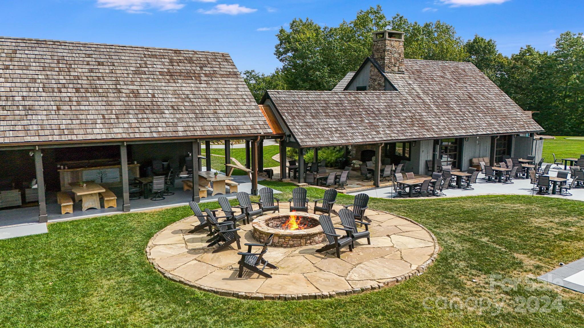 Lot D52 Springwater Road Glenville, NC 28736 - Photo 27 of 47 a patio with table and chairs potted plants and large tree