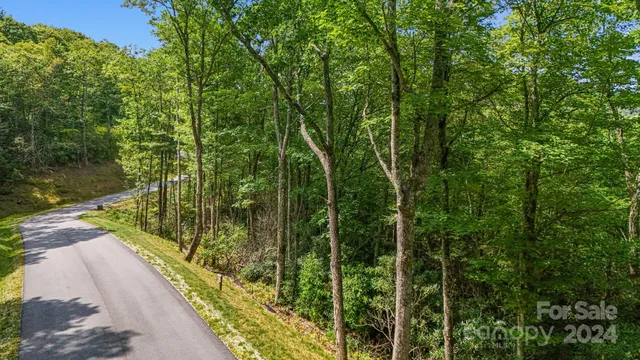 a sign broad in front of a red brick house