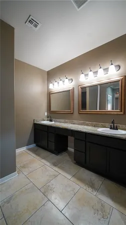 a spacious bathroom with a double vanity sink and a mirror