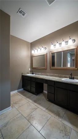a bathroom with a sink vanity and mirror