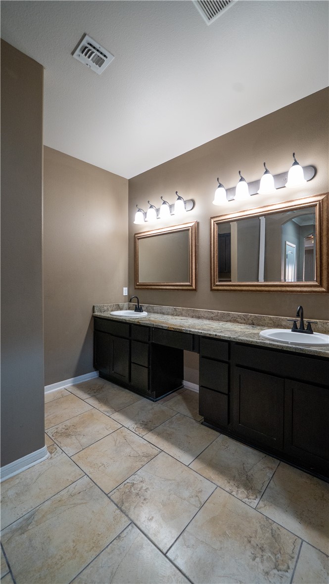 6809 Summer Wind Drive Corpus Christi, TX 78413 - Photo 17 of 27 a bathroom with a sink vanity and mirror