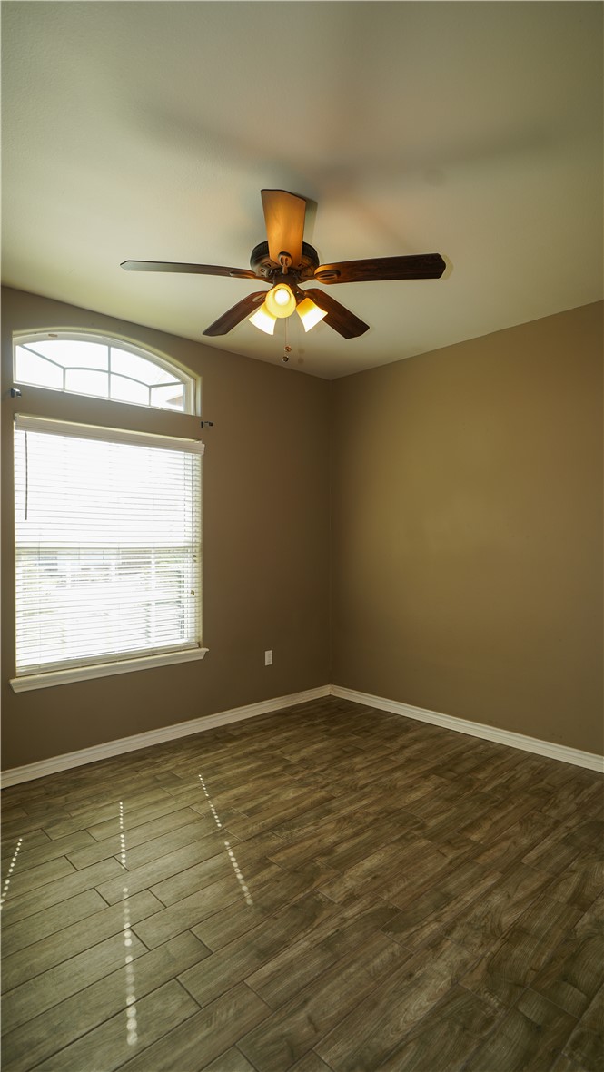 6809 Summer Wind Drive Corpus Christi, TX 78413 - Photo 21 of 27 a view of an empty room with window and chandelier fan