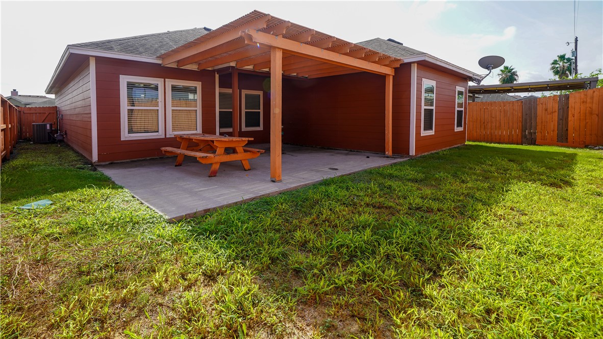 6809 Summer Wind Drive Corpus Christi, TX 78413 - Photo 27 of 27 a backyard of a house with barbeque oven table and chairs