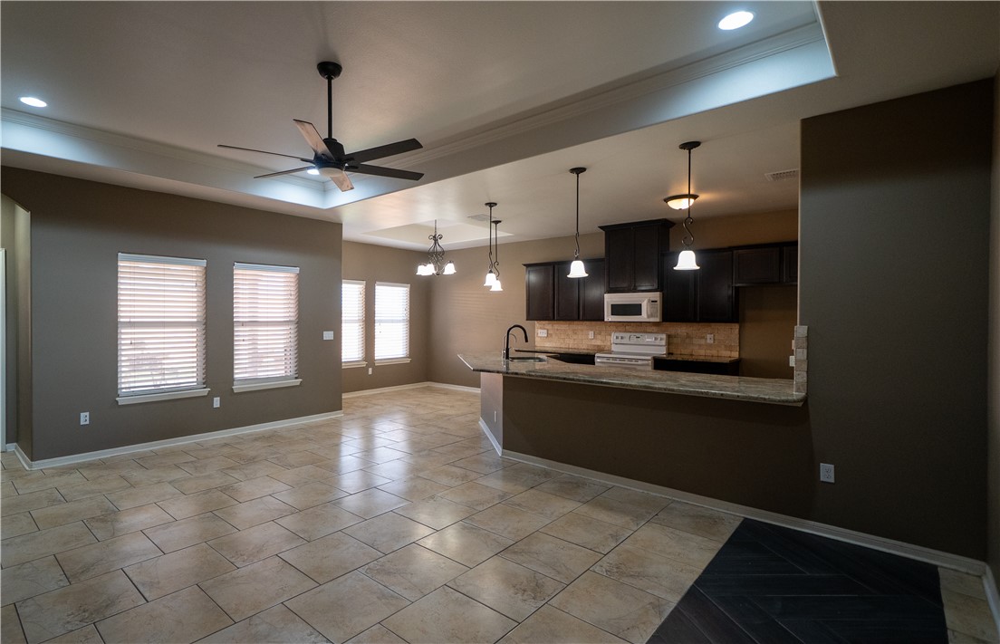 6809 Summer Wind Drive Corpus Christi, TX 78413 - Photo 4 of 27 a large room with chandelier fan and windows