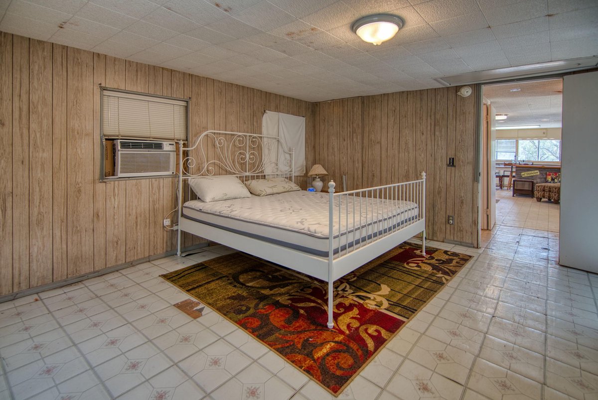 567 County Road 241 Rochelle, TX 76872 - Photo 22 of 31 Bedroom with wood walls and cooling unit