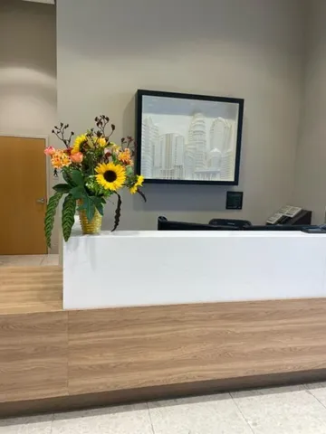 a view of a living room with a sink and mirror