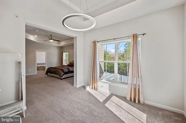 a view of a livingroom with a tub and large windows