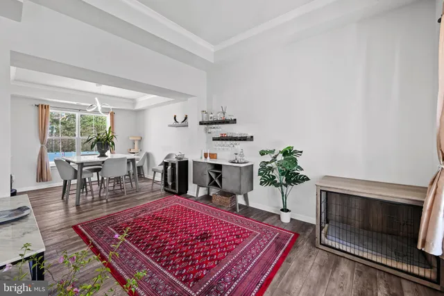 a living room with furniture a rug and a table