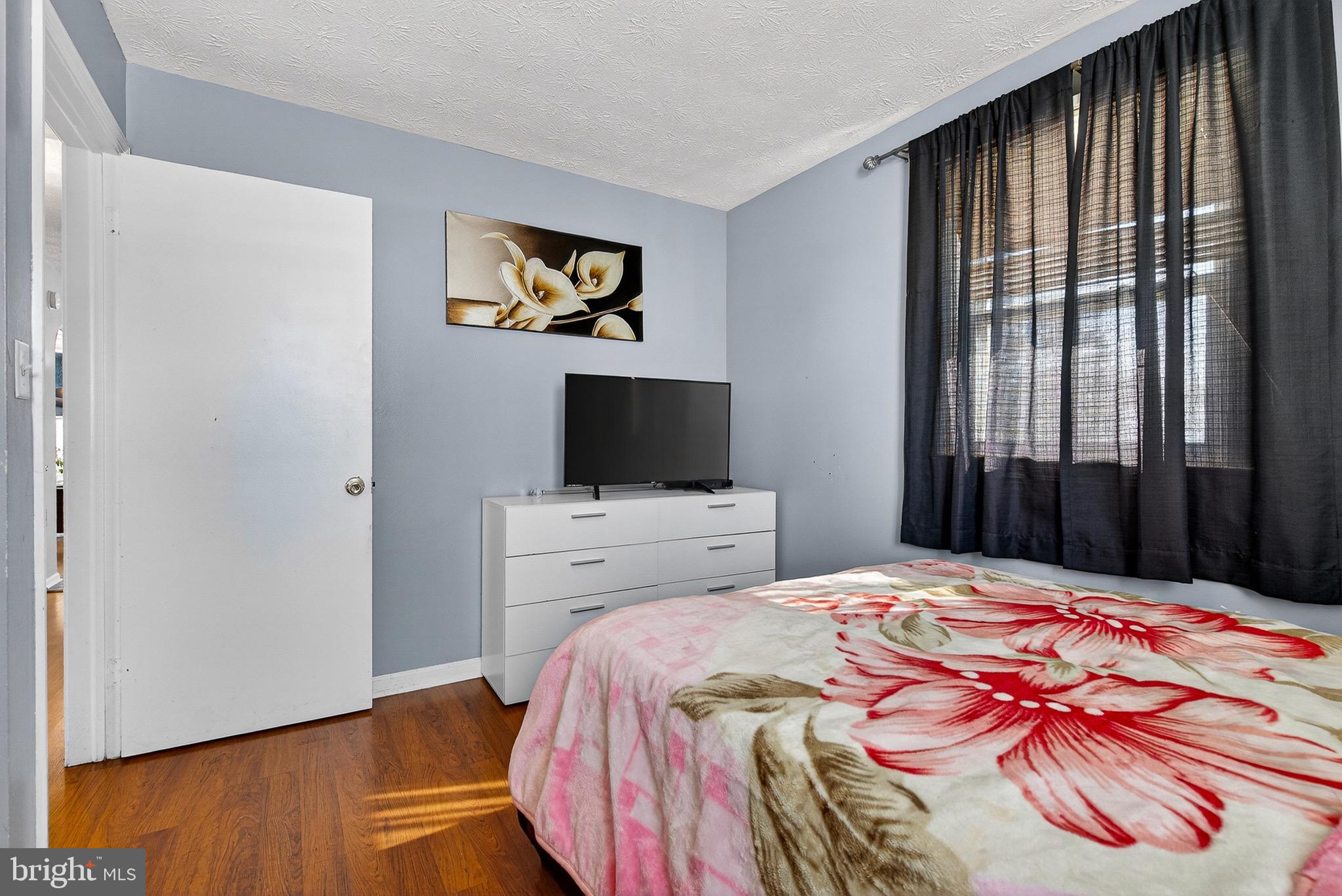 3505 East Joppa Road Parkville, MD 21234 - Photo 13 of 42 a bedroom with a bed and a flat screen tv