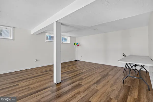 a view of a room with wooden floor
