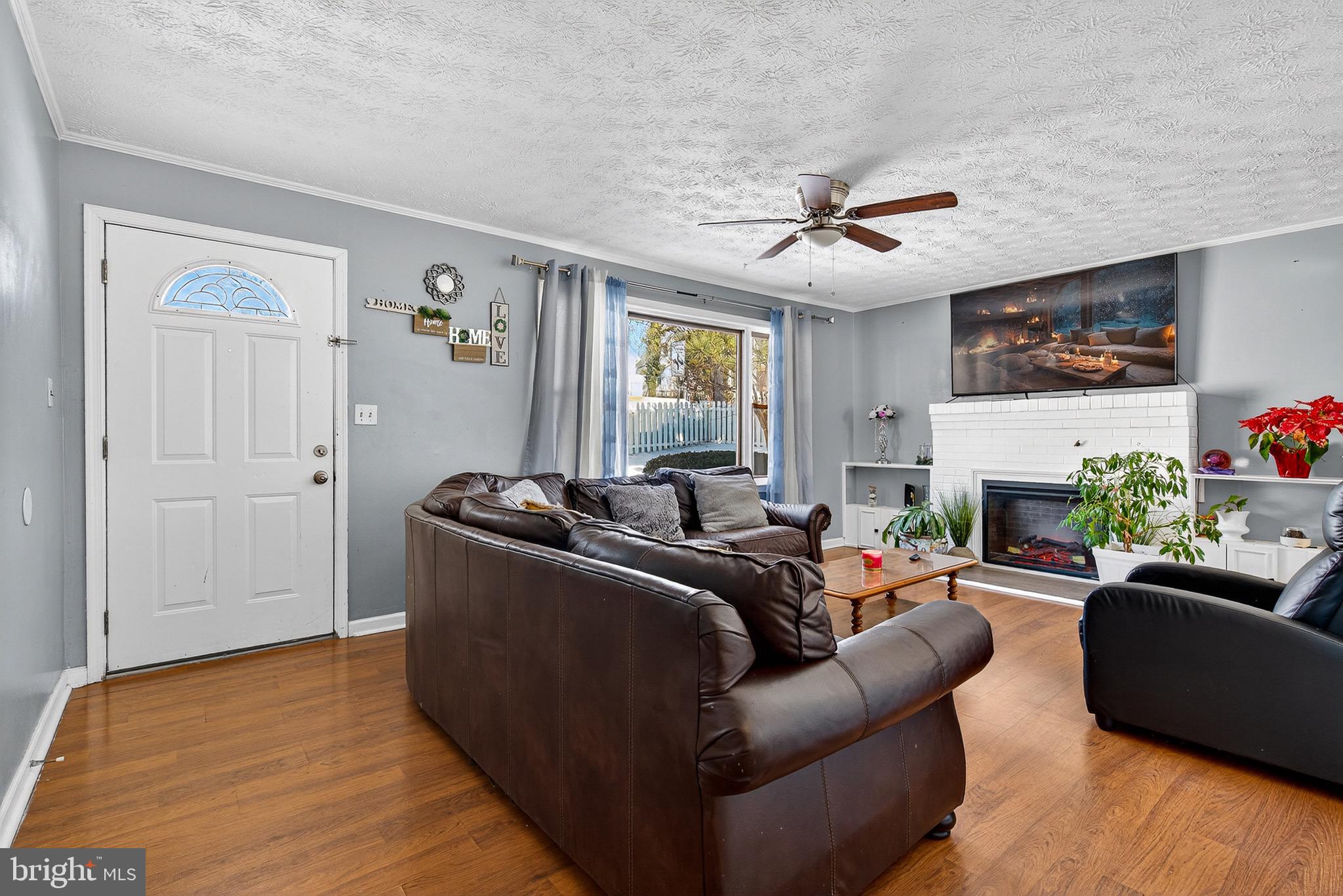 3505 East Joppa Road Parkville, MD 21234 - Photo 2 of 42 a living room with furniture a fireplace and a flat screen tv
