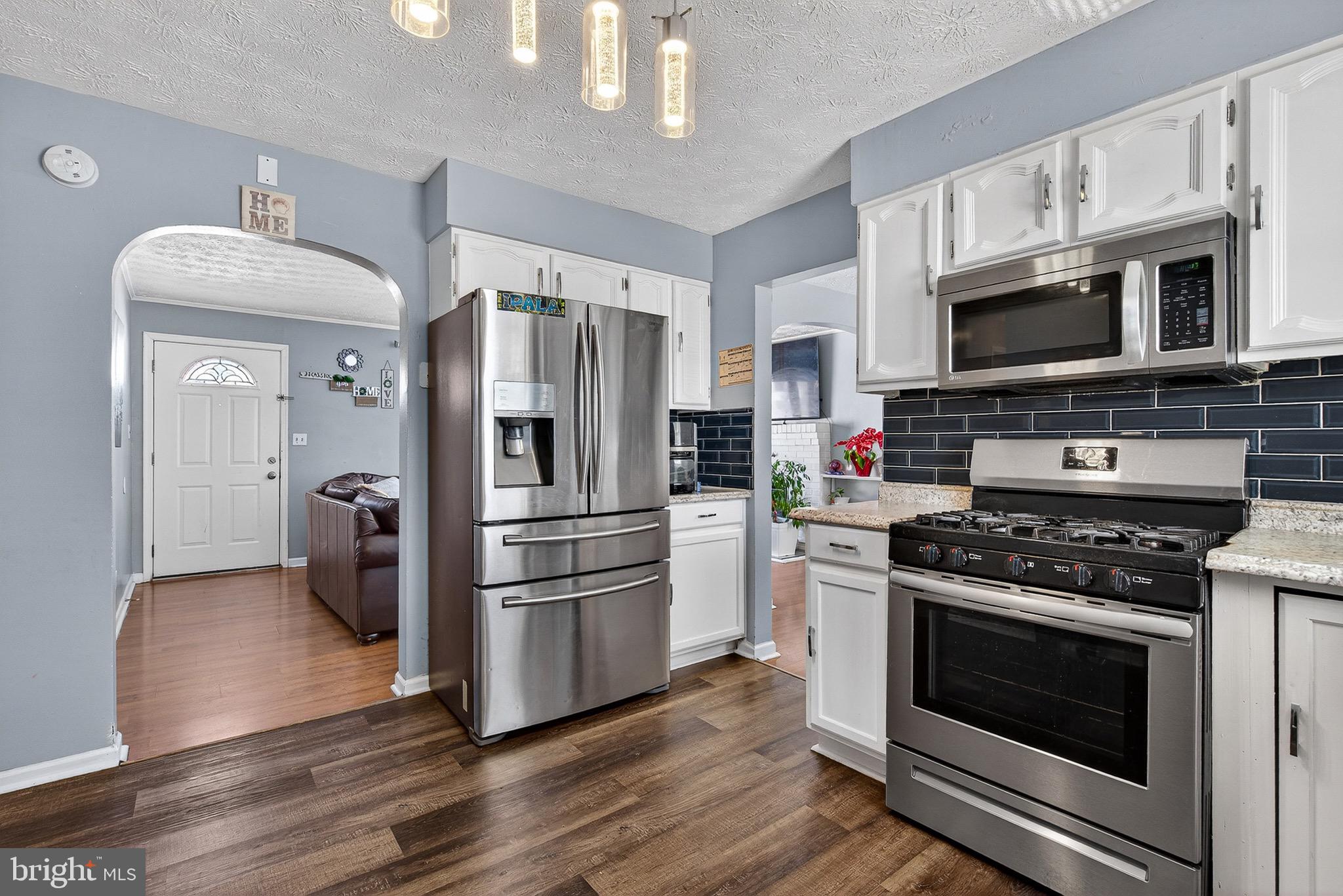 3505 East Joppa Road Parkville, MD 21234 - Photo 7 of 42 a kitchen with stainless steel appliances a stove a microwave and a refrigerator