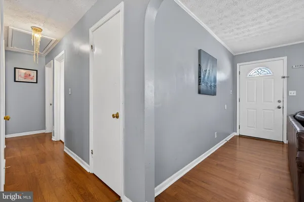 a view of a hallway with wooden floor