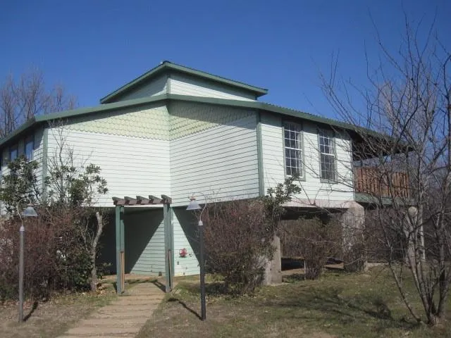 a backyard of a house with table and chairs