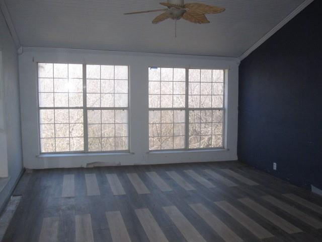 2150 Harris Street Gainesville, TX 76240 - Photo 4 of 20 a view of an empty room with wooden floor and a window