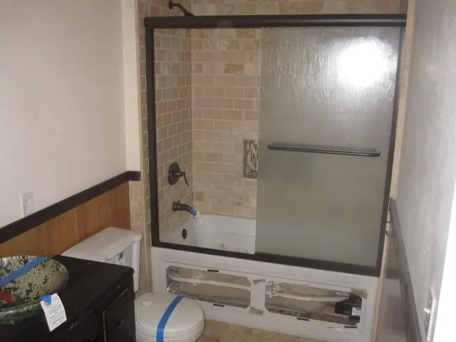 a bathroom with a shower and a sink