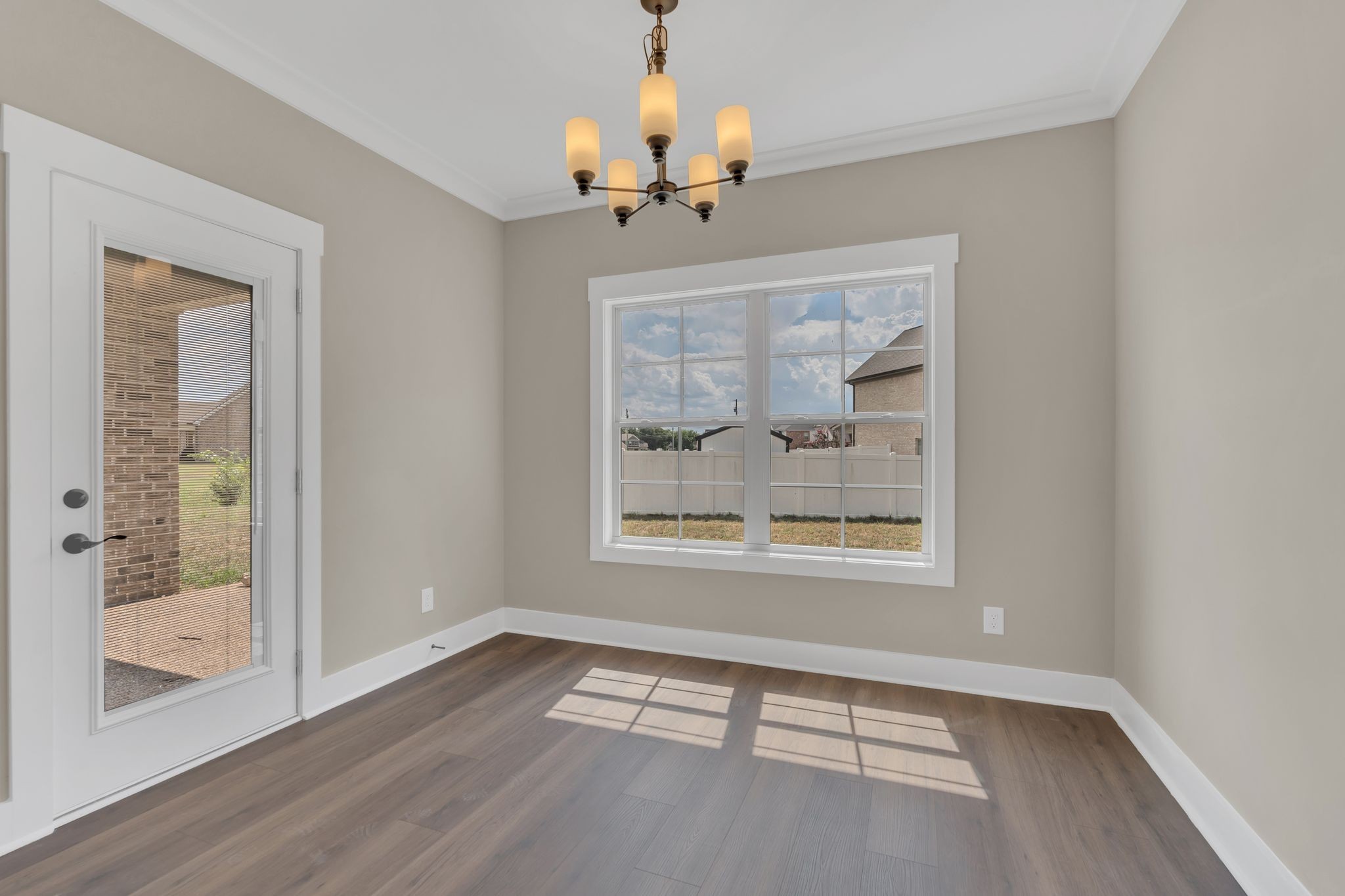 1170 Rimrock Road Smyrna, TN 37167 - Photo 11 of 33 a view of an empty room with wooden floor and a window