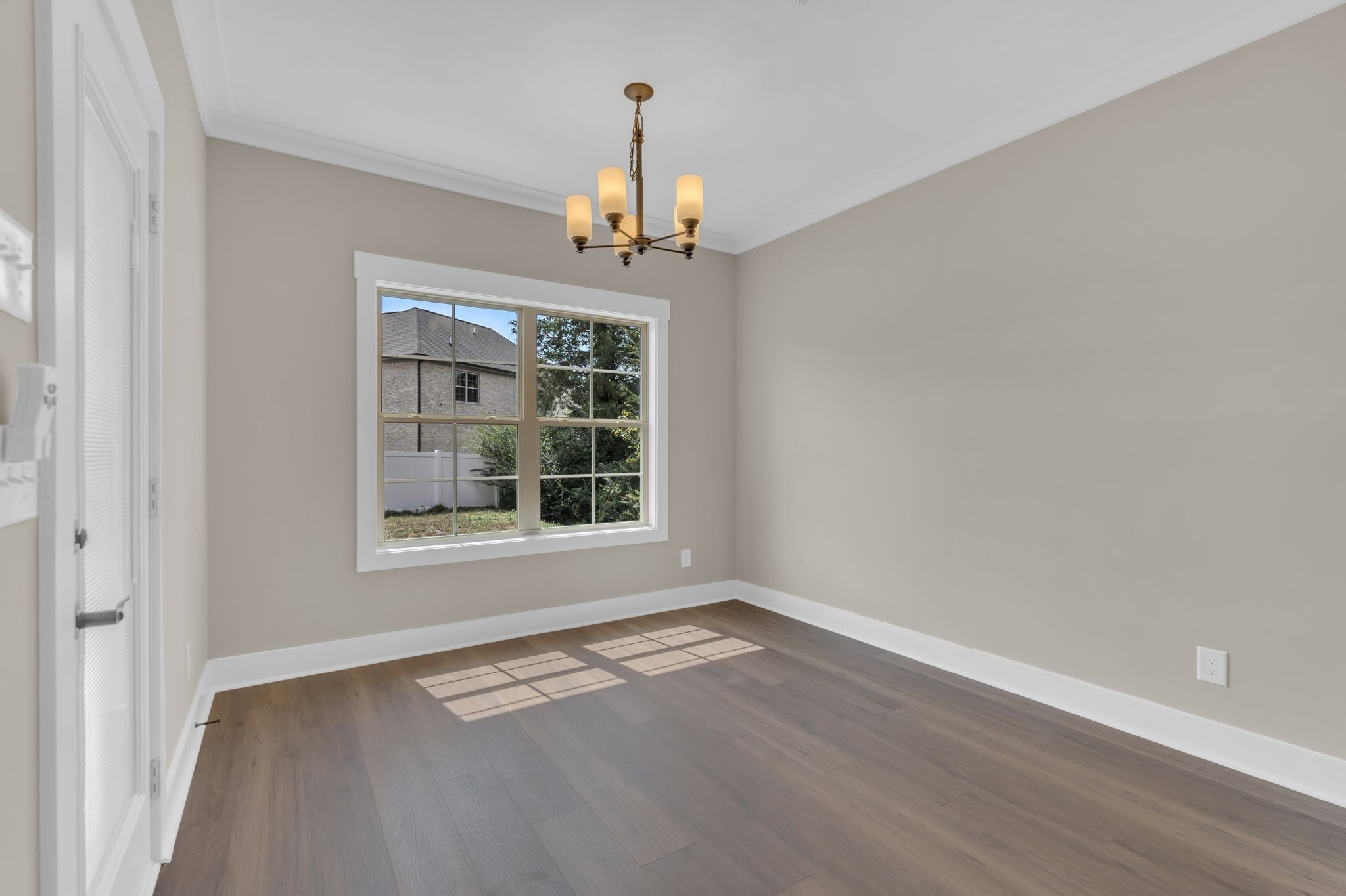 1170 Rimrock Road Smyrna, TN 37167 - Photo 10 of 33 a view of an empty room with wooden floor and a window