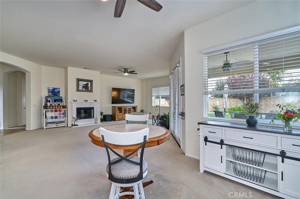 860 Annandale Road Beaumont, CA 92223 - Photo 17 of 61 a living room with furniture a window and a flat screen tv