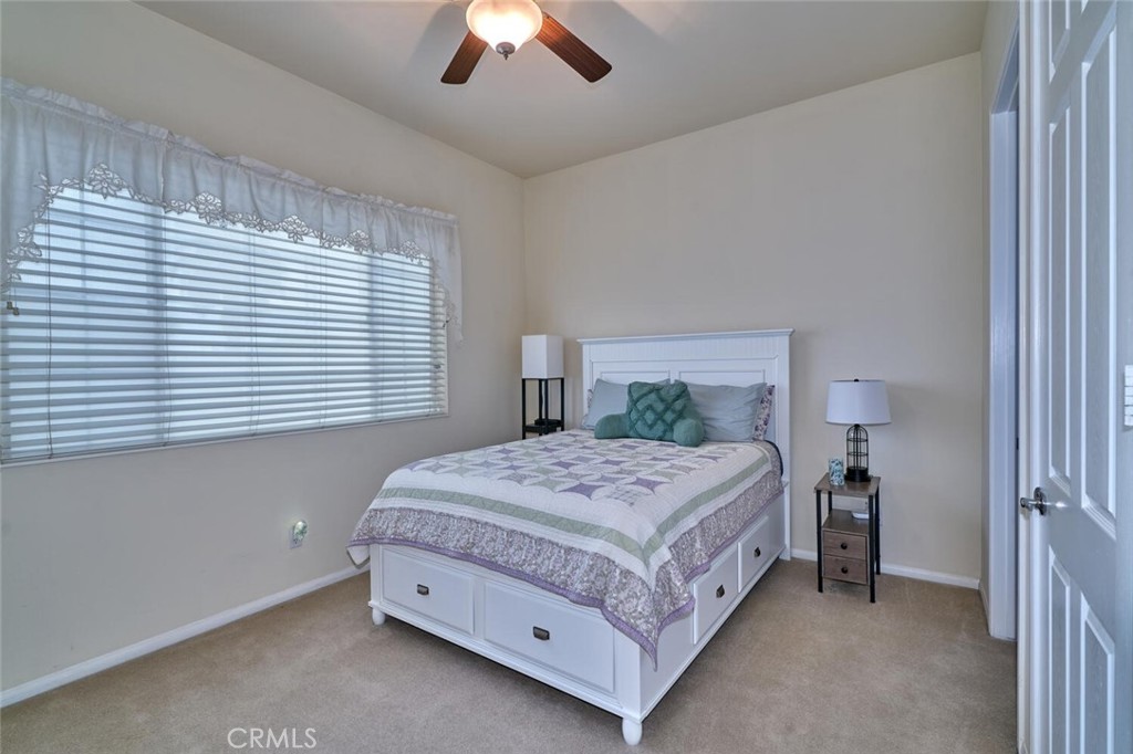 860 Annandale Road Beaumont, CA 92223 - Photo 33 of 61 a bedroom with a bed and a chandelier