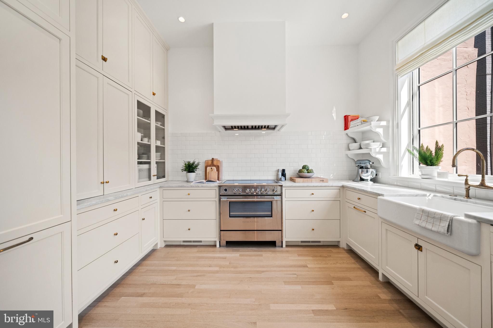 1304 S Street Northwest Washington, DC 20009 - Photo 2 of 23 a kitchen with white cabinets and white appliances