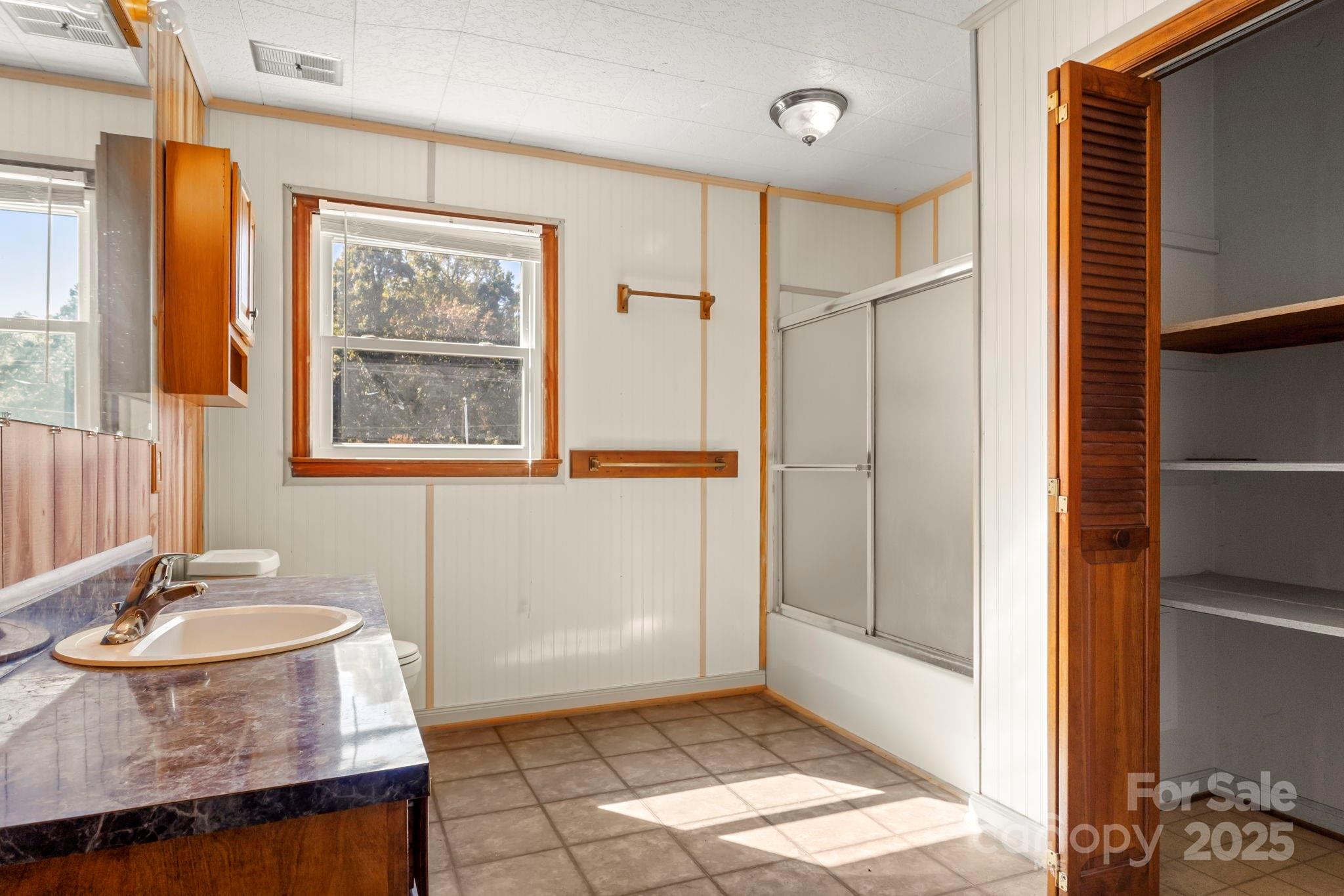 543 Blacksnake Road Stanley, NC 28164 - Photo 15 of 19 a bathroom with a granite countertop sink a mirror and a bathtub