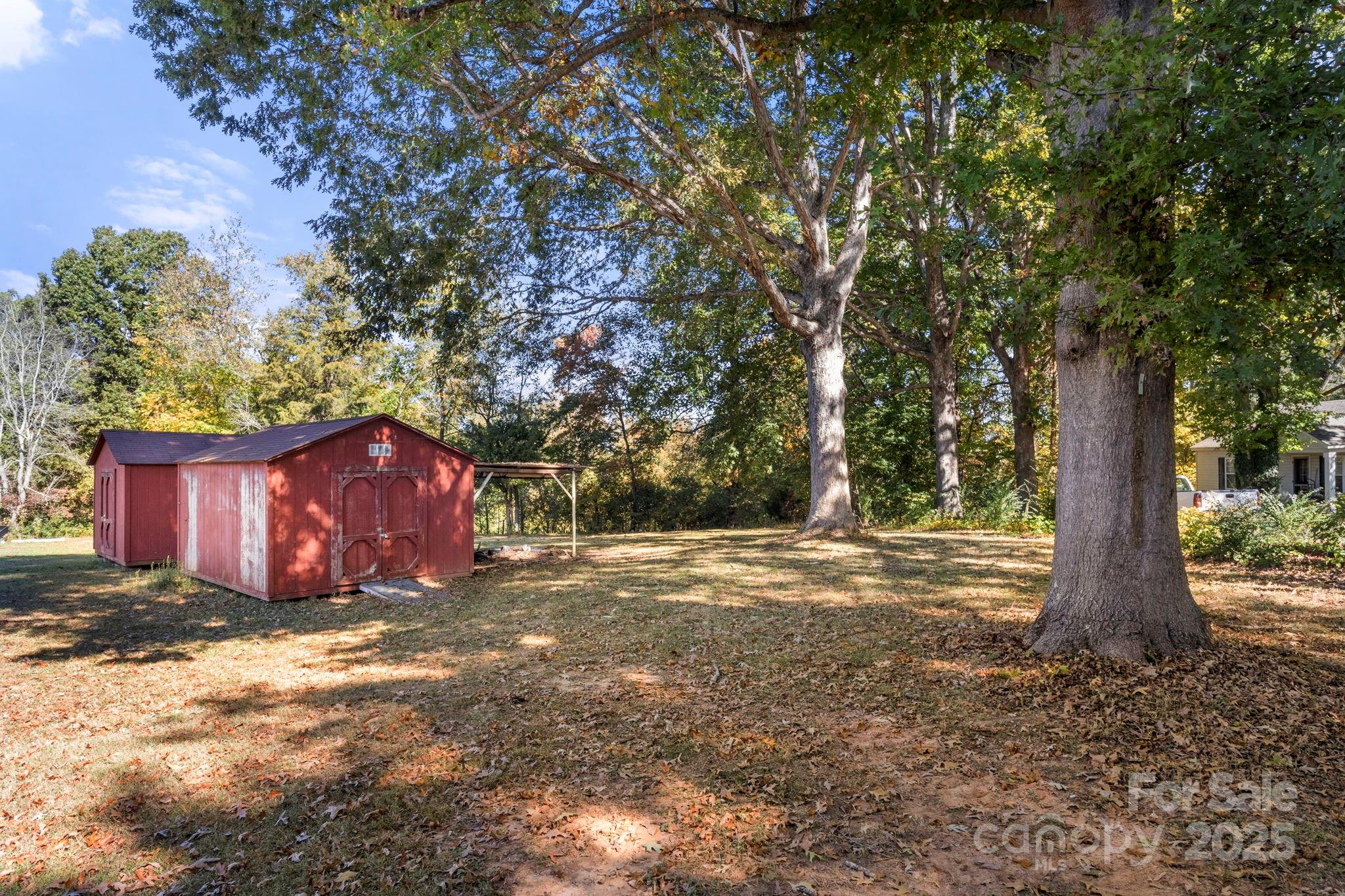543 Blacksnake Road Stanley, NC 28164 - Photo 18 of 19 a view of a yard with large tree